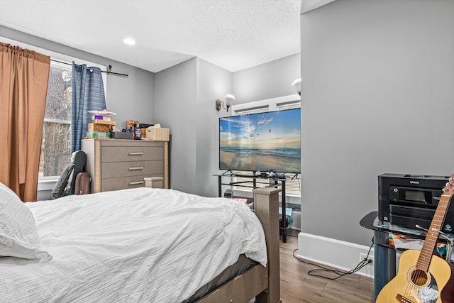 bedroom featuring a textured ceiling and hardwood / wood-style flooring