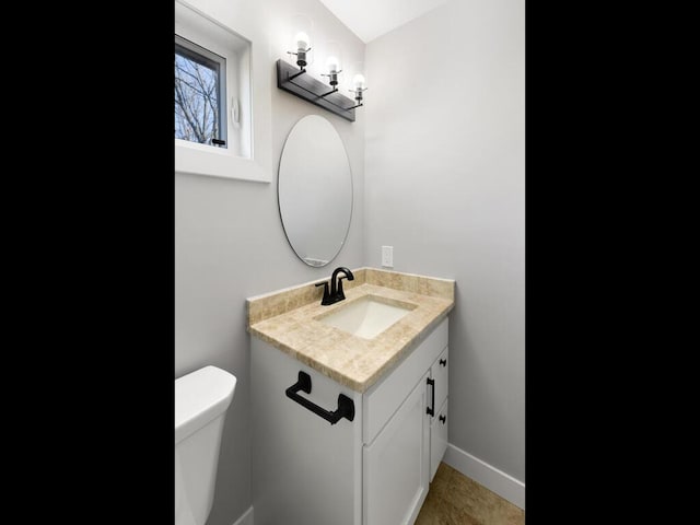 bathroom with vanity and toilet