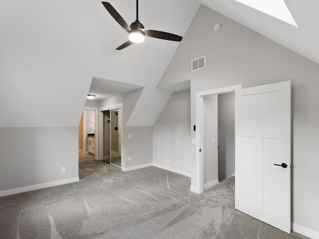 additional living space with ceiling fan, light colored carpet, and lofted ceiling