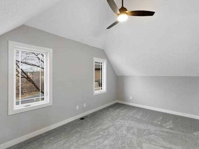 additional living space featuring light carpet, ceiling fan, and lofted ceiling