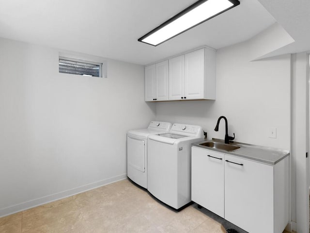 laundry area with cabinets, independent washer and dryer, and sink