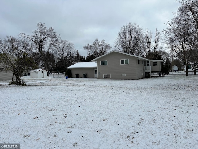 snow covered house with a storage shed