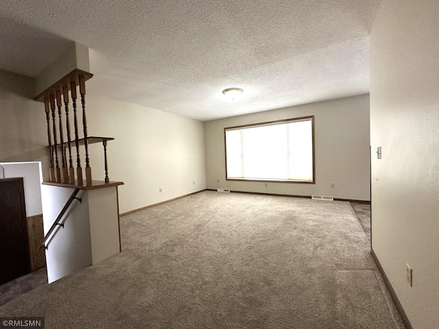 interior space featuring carpet and a textured ceiling