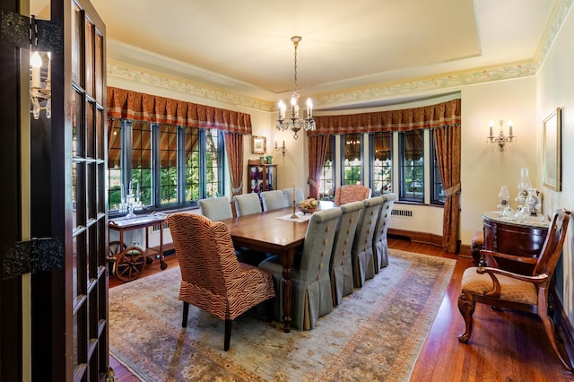 661 Market St, Winona, MN 55987 - dining room with plenty of natural light, wood-type flooring, radiator heating unit, and ornamental molding