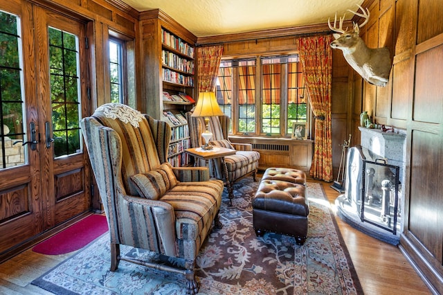 661 Market St, Winona, MN 55987 - living area with wood-type flooring, ornamental molding, wooden walls, and french doors