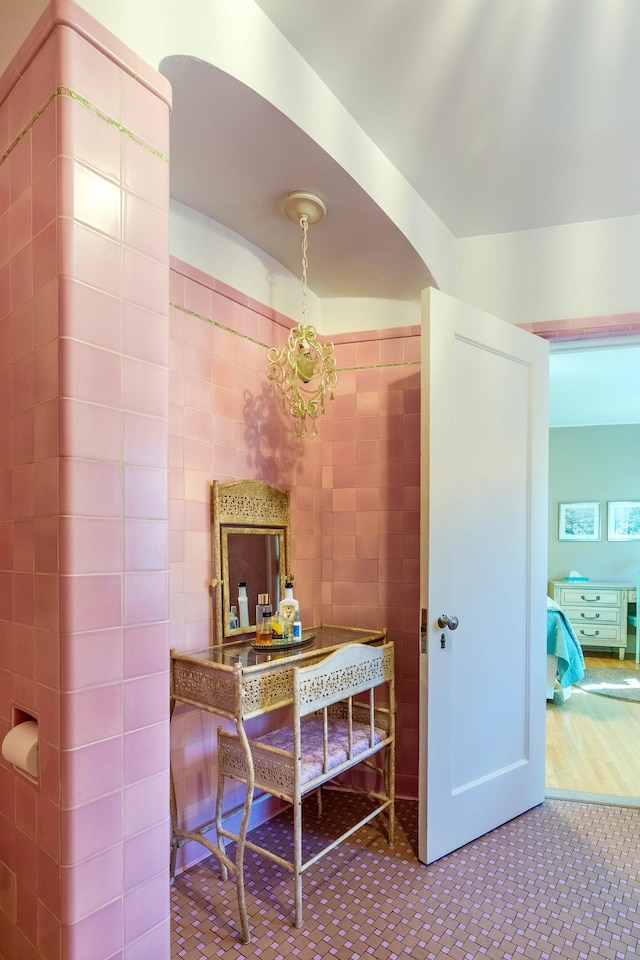 661 Market St, Winona, MN 55987 - hallway with a chandelier, tile patterned floors, and tile walls