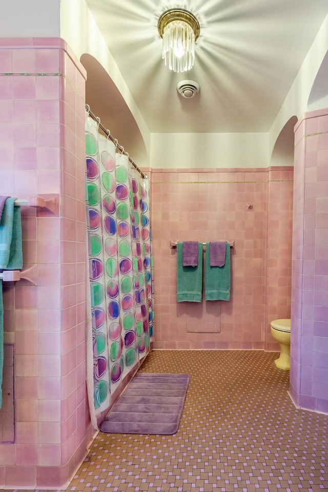 661 Market St, Winona, MN 55987 - bathroom with toilet, tile patterned flooring, tile walls, and walk in shower