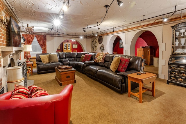 661 Market St, Winona, MN 55987 - carpeted cinema with a fireplace, a textured ceiling, track lighting, and crown molding