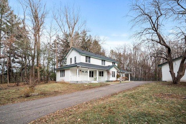 view of front of house with covered porch and a front yard