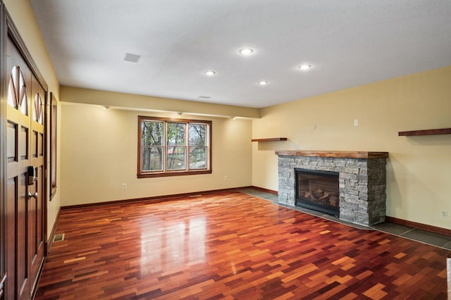 unfurnished living room featuring dark hardwood / wood-style flooring and a fireplace