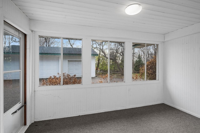 unfurnished sunroom with plenty of natural light and wooden ceiling