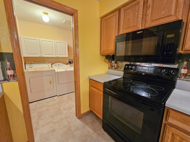 kitchen featuring washer and clothes dryer and black appliances