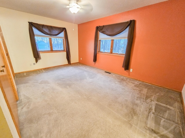 carpeted spare room featuring plenty of natural light