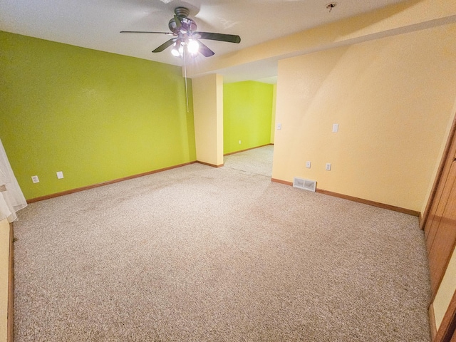 unfurnished room with ceiling fan and carpet flooring