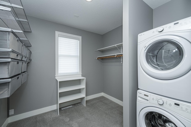 washroom featuring stacked washer and clothes dryer, a textured ceiling, laundry area, and carpet