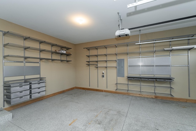 garage with baseboards, electric panel, and a garage door opener