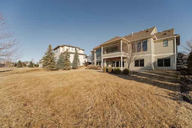 back of property featuring a yard