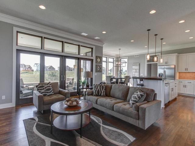 living room featuring baseboards, crown molding, recessed lighting, and dark wood-style flooring