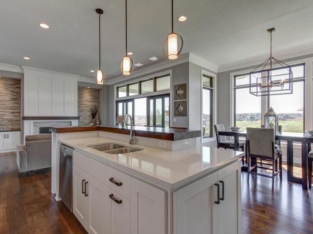 kitchen featuring open floor plan, a fireplace, a sink, and plenty of natural light