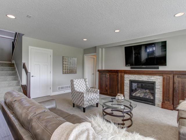living area featuring recessed lighting, carpet, stairs, and visible vents