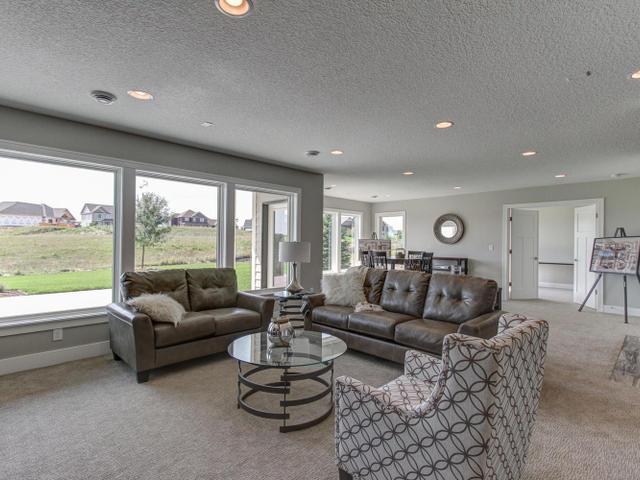 living room with baseboards, carpet floors, recessed lighting, and a textured ceiling