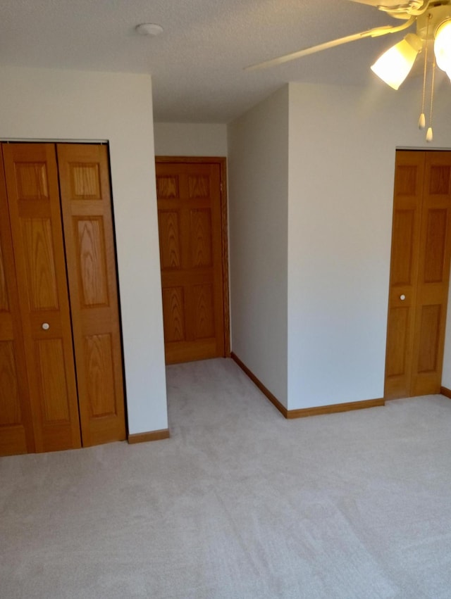 unfurnished bedroom featuring ceiling fan and light carpet