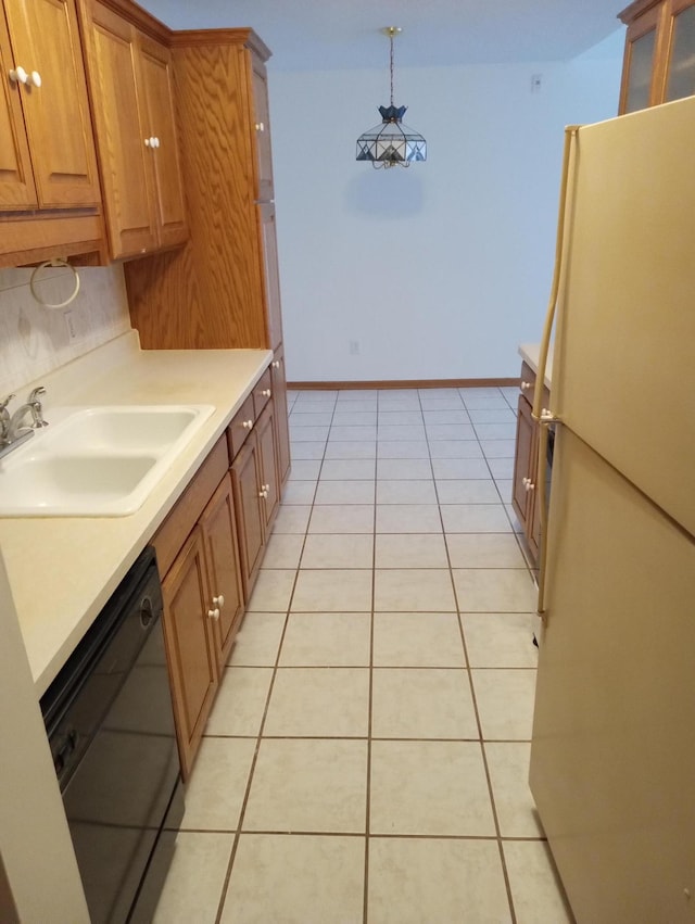 kitchen with dishwasher, decorative light fixtures, white fridge, sink, and light tile patterned floors