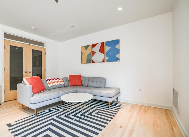 living room with french doors and wood-type flooring