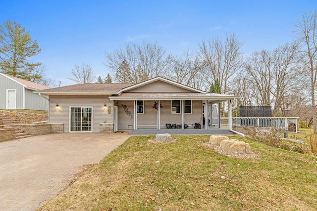 view of front of house featuring covered porch and a front lawn