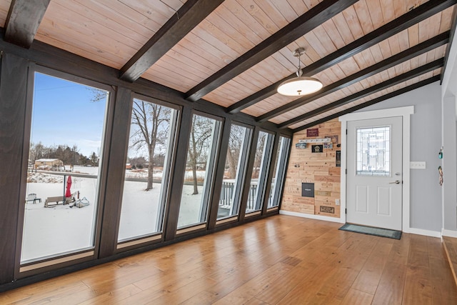 entrance foyer with lofted ceiling with beams, light wood-type flooring, wooden ceiling, and wooden walls