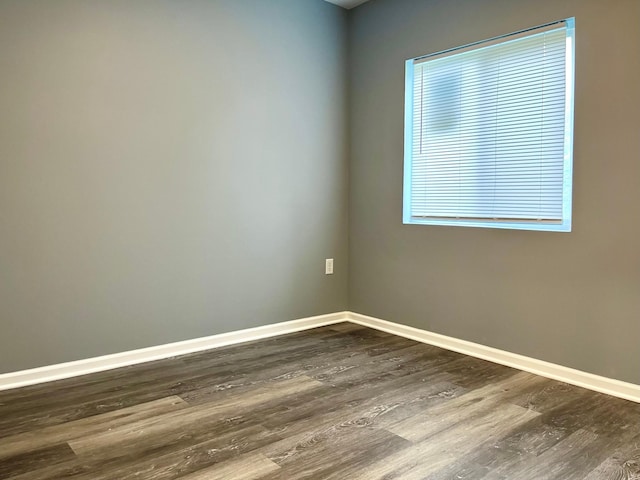 empty room featuring dark hardwood / wood-style flooring