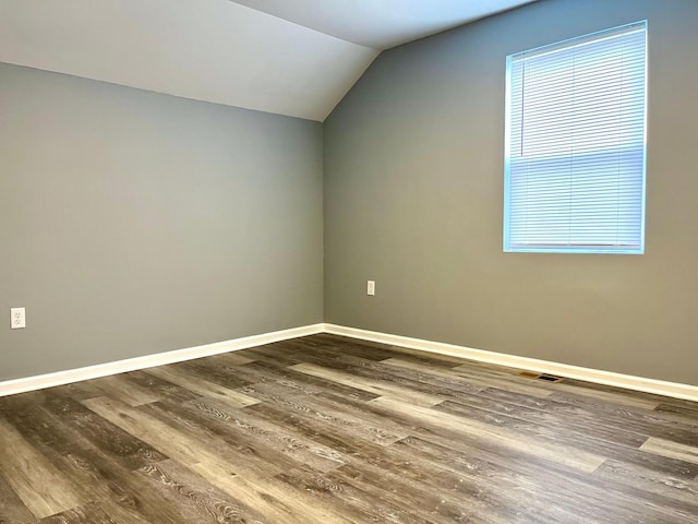 bonus room featuring dark hardwood / wood-style flooring and vaulted ceiling