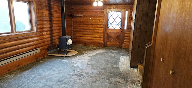 entryway with a wood stove and a healthy amount of sunlight