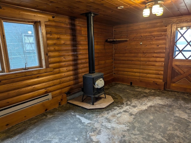 interior space with a wood stove, rustic walls, wooden ceiling, and a baseboard radiator