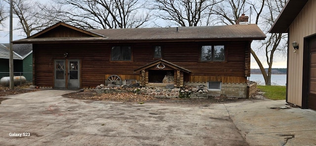 log home featuring a water view