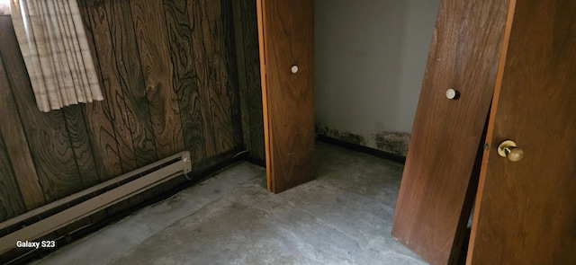 bathroom with concrete flooring and a baseboard radiator