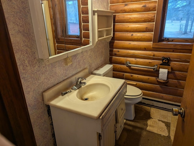 bathroom featuring log walls, vanity, and a wealth of natural light