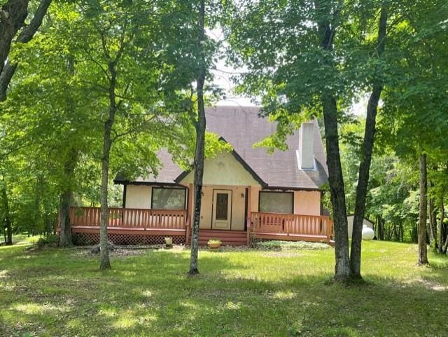 33820 County Highway 34, Sugar Bush E Twp, MN 56569 - rear view of property featuring a deck, a lawn, and stucco siding