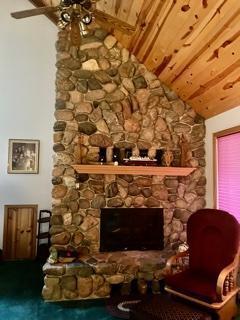 33820 County Highway 34, Sugar Bush E Twp, MN 56569 - living room featuring a fireplace, wooden ceiling, and a ceiling fan