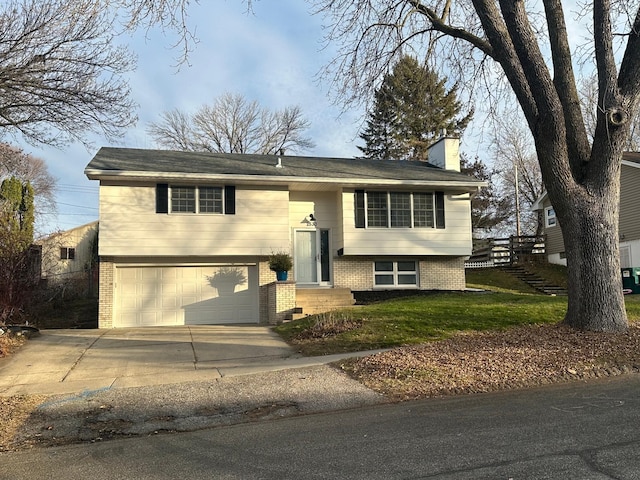 bi-level home featuring a front yard and a garage