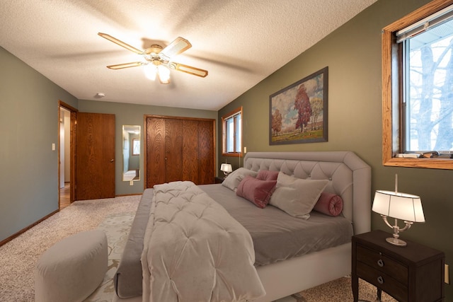 bedroom with carpet flooring, ceiling fan, and a textured ceiling