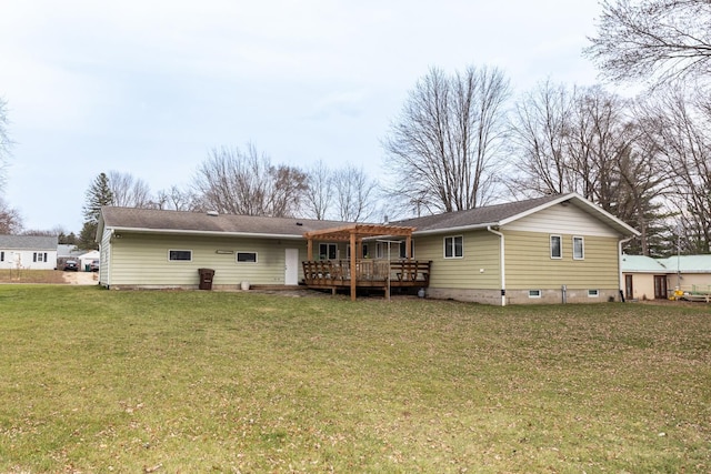 rear view of property featuring a yard and a deck