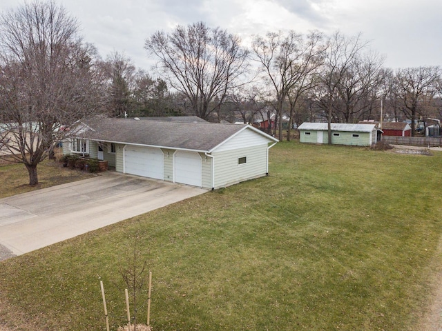 view of side of property with a garage and a lawn