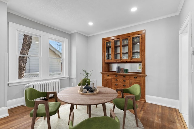 sitting room with dark hardwood / wood-style flooring, crown molding, and radiator