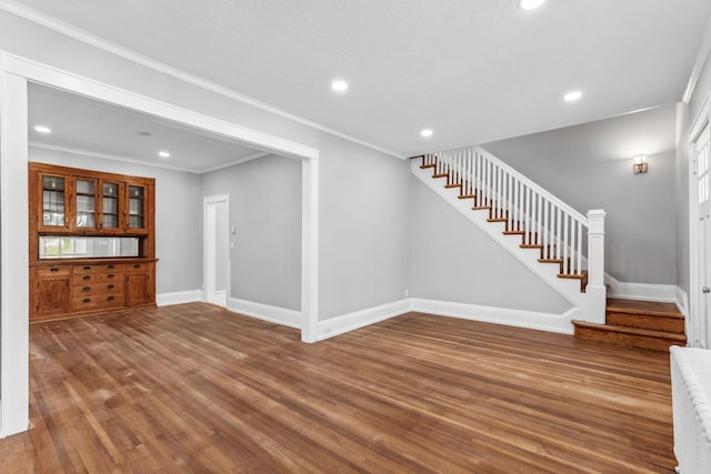 interior space with hardwood / wood-style floors and ornamental molding