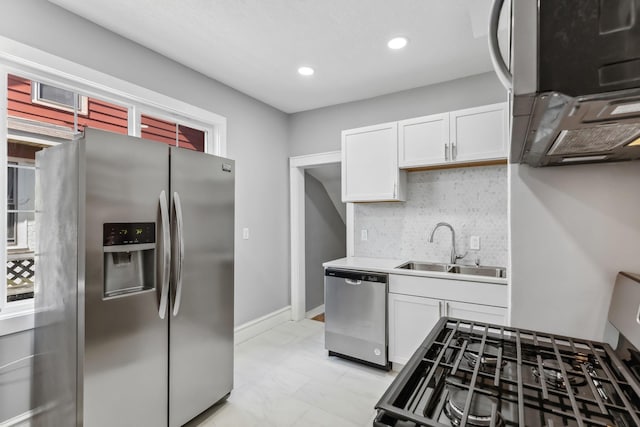 kitchen featuring tasteful backsplash, white cabinetry, sink, and appliances with stainless steel finishes