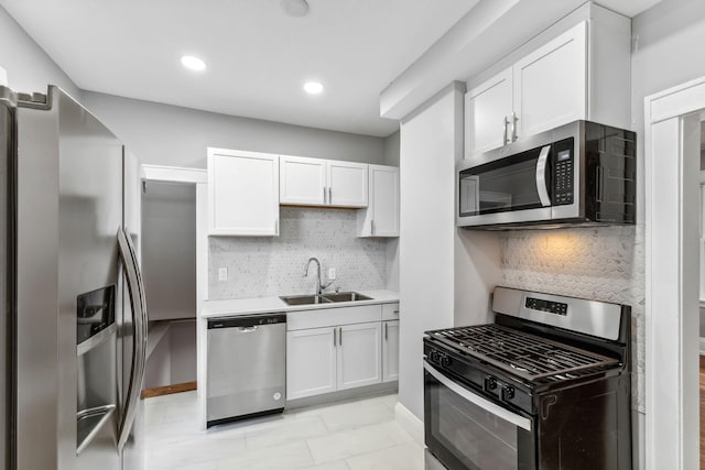 kitchen featuring white cabinets, backsplash, sink, and stainless steel appliances