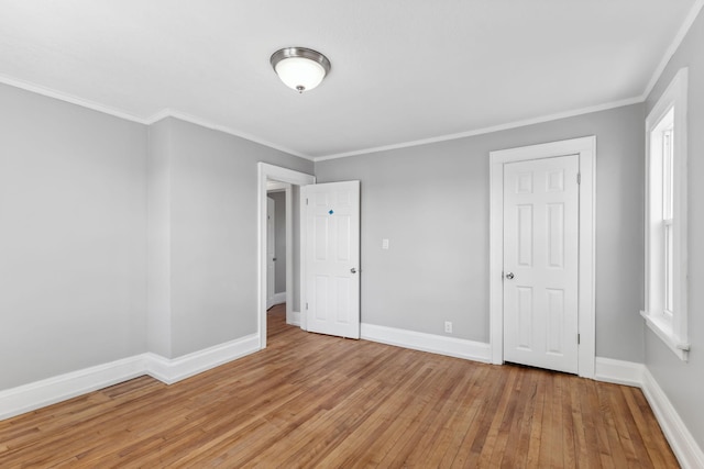 unfurnished bedroom featuring a closet, light hardwood / wood-style floors, and ornamental molding