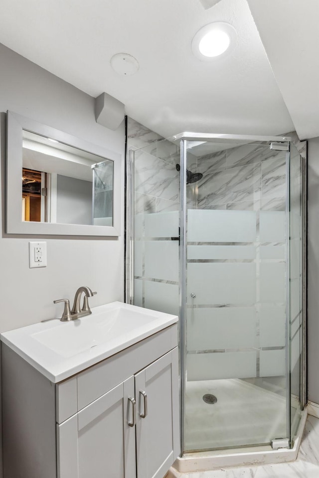 bathroom featuring vanity and a shower with shower door