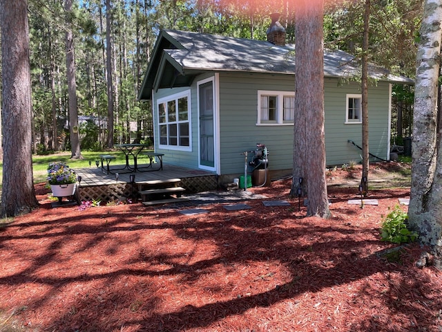 view of side of property with a wooden deck